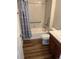 Bathroom featuring tub-shower combo, modern fixtures, and wood look floors at 22822 E Union Cir, Aurora, CO 80015