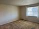 Carpeted bedroom with a large window allowing natural light and views of the outdoors at 22822 E Union Cir, Aurora, CO 80015