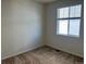 Cozy bedroom featuring neutral carpet and natural light from a window with blinds at 22822 E Union Cir, Aurora, CO 80015