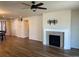Living room featuring modern fireplace, wood-look flooring, neutral walls, and tv mounting bracket at 22822 E Union Cir, Aurora, CO 80015