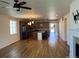 Open-concept living space with wood-look flooring leading to an island kitchen with barstool seating at 22822 E Union Cir, Aurora, CO 80015