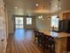 Cozy living space features an island with seating, wood-look floors, and sliding glass door at 22822 E Union Cir, Aurora, CO 80015