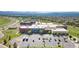 Aerial view of Prospect Ridge Academy High School with a parking lot and surrounding greenery at 2647 Gray Wolf Loop, Broomfield, CO 80023