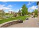 Serene backyard featuring a stone patio, lush greenery, and views of neighboring houses at 2647 Gray Wolf Loop, Broomfield, CO 80023