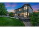 Well-maintained backyard with a grass lawn, stone patio, and built-in seating, perfect for outdoor entertaining at 2647 Gray Wolf Loop, Broomfield, CO 80023
