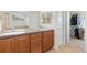 Bright bathroom with double sinks and a closet with organized hanging clothes at 2647 Gray Wolf Loop, Broomfield, CO 80023