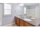 Bright bathroom featuring a double vanity with modern fixtures and a shower with a white curtain at 2647 Gray Wolf Loop, Broomfield, CO 80023