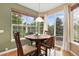Cozy breakfast nook featuring a round table, natural light from windows, and a view of the outdoor patio at 2647 Gray Wolf Loop, Broomfield, CO 80023