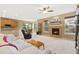 Spacious living room with fireplace, TV, and comfortable furniture, blending relaxation and entertainment at 2647 Gray Wolf Loop, Broomfield, CO 80023
