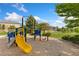 A neighborhood playground with climbing equipment, slides, and a rope bridge set in a grassy area at 2647 Gray Wolf Loop, Broomfield, CO 80023