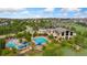 Aerial view of a community pool and clubhouse with water slides, pool, and a well-maintained surrounding area at 2647 Gray Wolf Loop, Broomfield, CO 80023