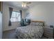 Comfortable bedroom with a window, desk setup, and patterned bedding at 11277 Osage Cir # E, Westminster, CO 80234