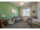 Cozy Bedroom with green accent wall, crib, and comfortable armchair at 11277 Osage Cir # E, Westminster, CO 80234
