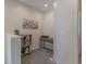 Functional upstairs landing with a bookshelf, desk, and neutral carpeting at 11277 Osage Cir # E, Westminster, CO 80234