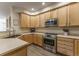 Updated kitchen with stainless steel oven and wood cabinets with countertops at 11277 Osage Cir # E, Westminster, CO 80234