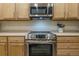 Well-equipped kitchen with stainless steel oven and range, offering modern cooking at 11277 Osage Cir # E, Westminster, CO 80234