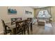 Inviting living space with dining table, sectional sofa, and large window at 11277 Osage Cir # E, Westminster, CO 80234
