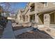 View of townhome exteriors featuring stone accents, private balconies, and landscaped common areas at 11277 Osage Cir # E, Westminster, CO 80234