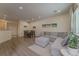 Bright living room features an open floor plan, wood floors, and large windows for ample natural light at 11277 Osage Cir # E, Westminster, CO 80234