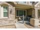 Private patio area with stone detailing, outdoor seating, and space for a grill at 11277 Osage Cir # E, Westminster, CO 80234