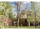 Expansive backyard featuring mature flowering trees and lush lawn, with a sunroom extension at 6285 W 35Th Ave, Wheat Ridge, CO 80033