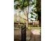 Stone pathway along backyard iron fence, surrounded by mature trees and lush landscaping at 6285 W 35Th Ave, Wheat Ridge, CO 80033
