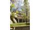 Spacious backyard featuring a sunroom extension and well-manicured lawn, framed by mature trees at 6285 W 35Th Ave, Wheat Ridge, CO 80033
