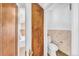 View of the bathroom with a toilet, bathtub, and storage at 6285 W 35Th Ave, Wheat Ridge, CO 80033