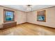Well-lit bedroom featuring hardwood floors, neutral walls, two windows, and a radiator at 6285 W 35Th Ave, Wheat Ridge, CO 80033