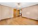 Neutral-colored bedroom featuring hardwood floors and two closet doors at 6285 W 35Th Ave, Wheat Ridge, CO 80033
