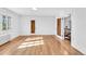Bright bedroom with hardwood floors, two doors, and windows with lattice design at 6285 W 35Th Ave, Wheat Ridge, CO 80033