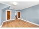 Large bedroom with hardwood floors, blue walls, and closet access at 6285 W 35Th Ave, Wheat Ridge, CO 80033