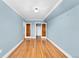 Bedroom with light blue walls, hardwood floors, and closet access at 6285 W 35Th Ave, Wheat Ridge, CO 80033