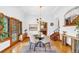 Open concept dining room featuring a round dining table and hardwood floors at 6285 W 35Th Ave, Wheat Ridge, CO 80033
