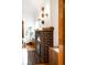 Close-up of the brick fireplace with an arched opening and beautiful sconces at 6285 W 35Th Ave, Wheat Ridge, CO 80033