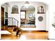 Staircase and wrought iron details in the foyer with beautiful hardwood floors and light fixtures at 6285 W 35Th Ave, Wheat Ridge, CO 80033