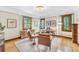 Bright home office with hardwood floors, traditional moldings, and comfortable seating at 6285 W 35Th Ave, Wheat Ridge, CO 80033