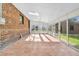 Bright sunroom with skylights, brick walls, and sliding glass doors at 6285 W 35Th Ave, Wheat Ridge, CO 80033