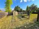 View of shed in yard featuring sparse grass, trees, and wooden fence at 9852 W 76Th Ave, Arvada, CO 80005