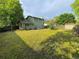Spacious backyard featuring a two story house, shed, grass, and privacy fence at 9852 W 76Th Ave, Arvada, CO 80005