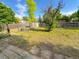 Large backyard featuring a shed, grass, and wooden fence, with a tree in the center at 9852 W 76Th Ave, Arvada, CO 80005