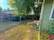 Lush backyard featuring a garden, mature trees, and a wooden privacy fence at 9852 W 76Th Ave, Arvada, CO 80005