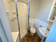 Bright bathroom with a glass-enclosed shower, toilet, and pedestal sink at 9852 W 76Th Ave, Arvada, CO 80005