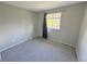 Neutral-toned bedroom with a window for natural light and plush carpeting at 9852 W 76Th Ave, Arvada, CO 80005