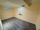 Simple bedroom featuring two windows, light walls and gray vinyl flooring at 9852 W 76Th Ave, Arvada, CO 80005