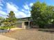 Two-story home with a green exterior, brick accents, and mature trees at 9852 W 76Th Ave, Arvada, CO 80005