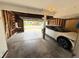 A spacious garage with an open door, room for a vehicle, and exposed framing at 9852 W 76Th Ave, Arvada, CO 80005