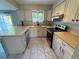 Updated kitchen with granite countertops, stainless steel appliances, and white cabinetry at 9852 W 76Th Ave, Arvada, CO 80005