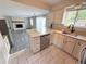 Spacious kitchen with granite countertops, stainless steel appliances, and white cabinets at 9852 W 76Th Ave, Arvada, CO 80005