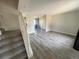 Open living room with new flooring, neutral walls, and staircase at 9852 W 76Th Ave, Arvada, CO 80005
